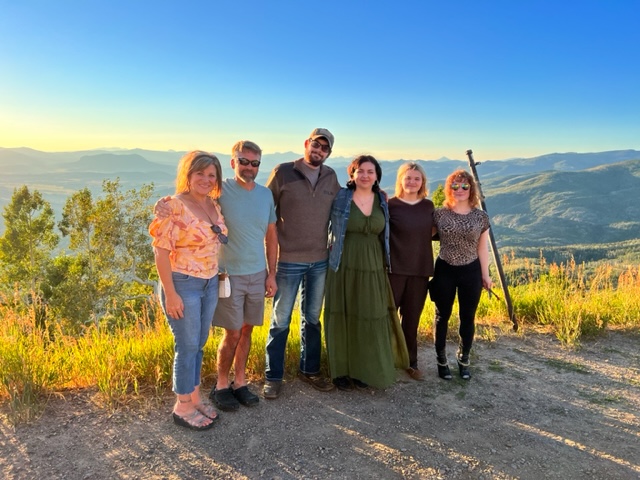 Dawn Leone, realtor, with her family and a view of the mountains in the background.