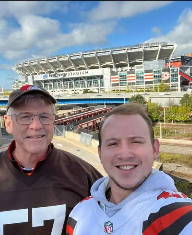 Jan McInturf and man wearing Cleveland Browns jerseys outside of the football stadium.