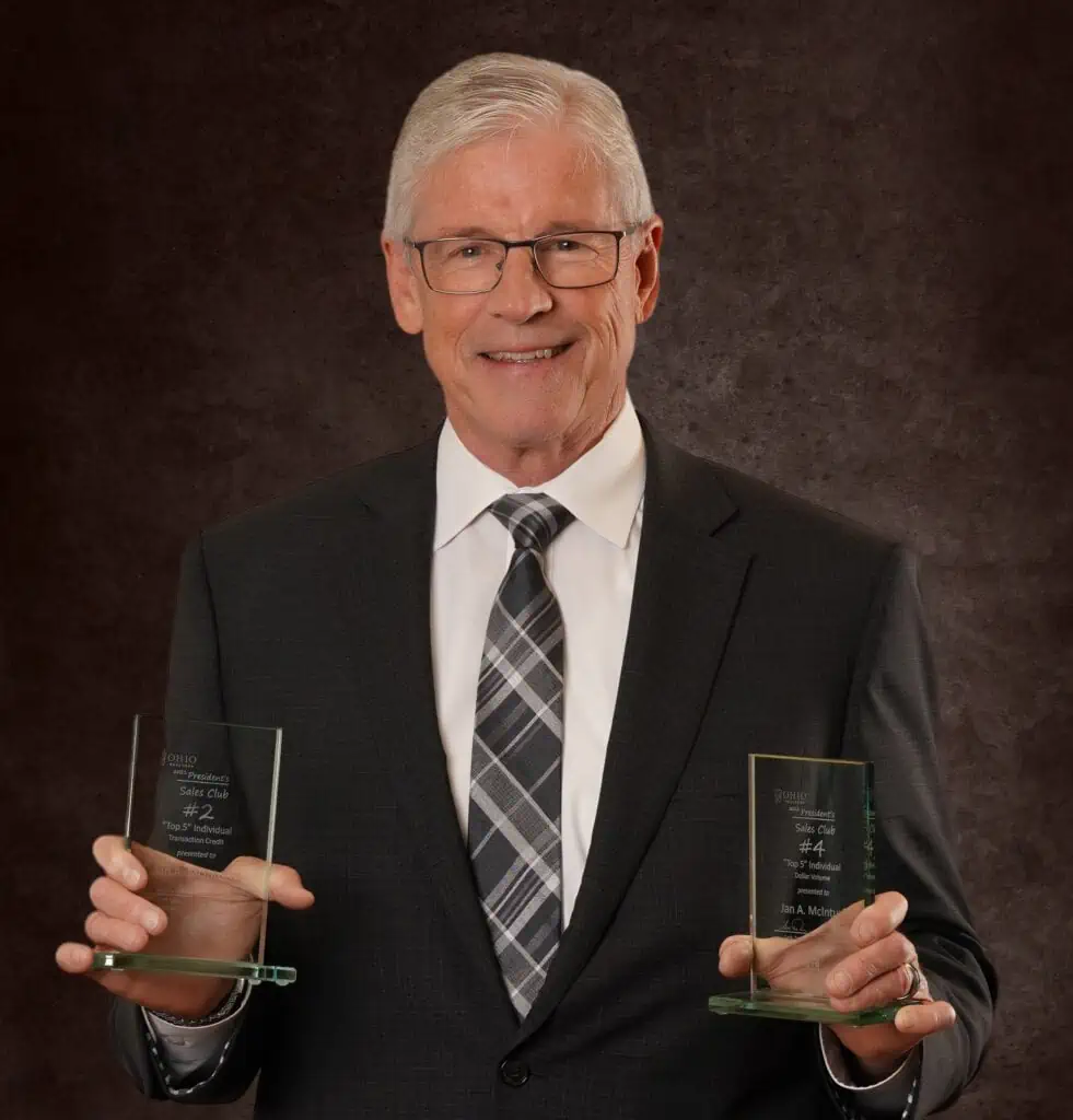 Realtor and broker Jan McInturf holding awards.