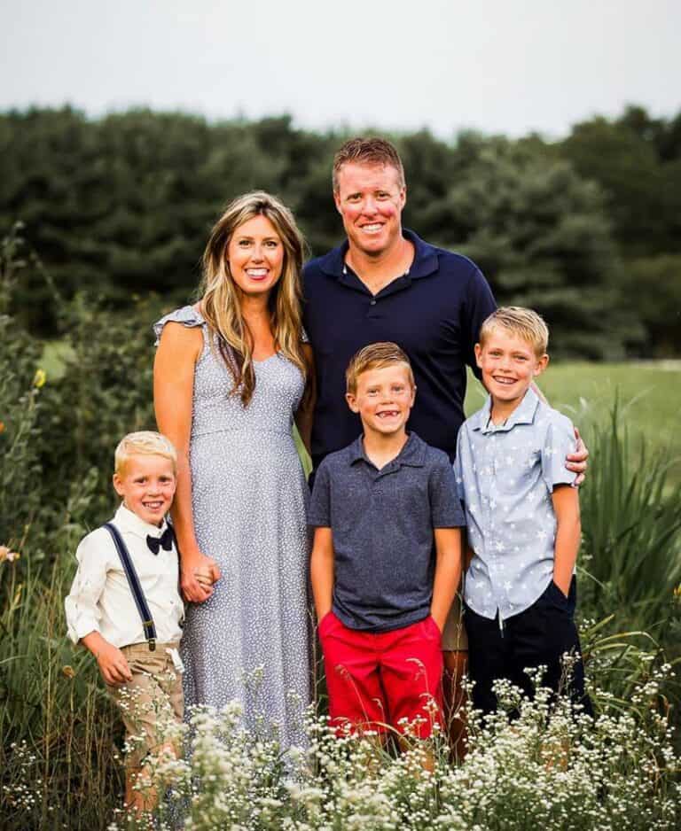 Scotty Jones realtor with wife and three sons in a field.